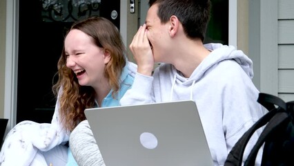in hands of a computer sit on the porch cover yourself with a blanket laugh sincerely teenagers communicate interesting stories gossip stories discussion conversation with friends