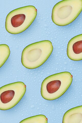 pattern set of avocado cut in half on a light blue background with drops