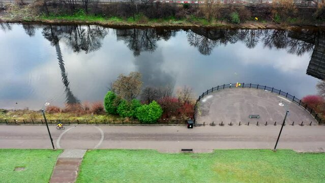 Aerial shot of cyclist next to River Clyde in Glasgow, Scotland