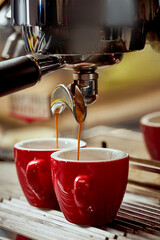 Preparation of espresso in a coffee machine. Hot coffee is poured into a cup