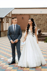 Fototapeta premium the first meeting of the bride and groom in the courtyard of the hotel