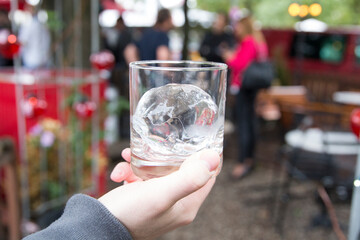 A professional bartender showing off a perfect ice bucket for drinks.