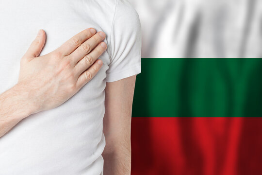 Bulgarian person with hand on heart on the background of Bulgary flag. Patriotism, country, national, pride concept
