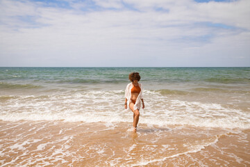 person walking on the beach