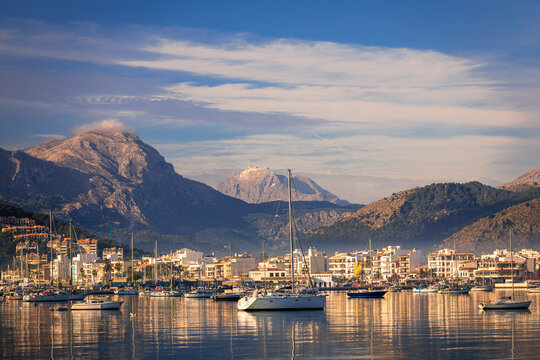 Calm morning walk along the seafront of port de Pollenca Majorca and the magnificent views of the bay and Tramuntana mountains backdrop