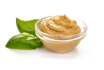 Mustard sauce in bowl, close-up, isolated on white background.