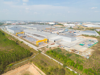 Fototapeta na wymiar Aerial top view of industry factory in urban city town. Inventory import and export business commercial, Automobile and automotive industry distribution logistic transport.