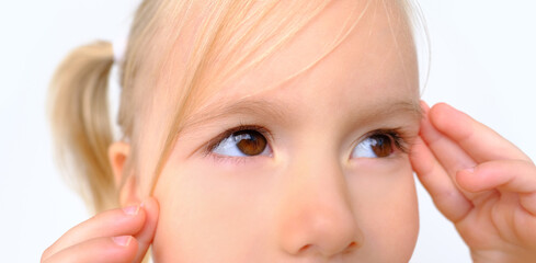close up part human eyes of little child 3 years old, blonde girl looking to side, concept of...