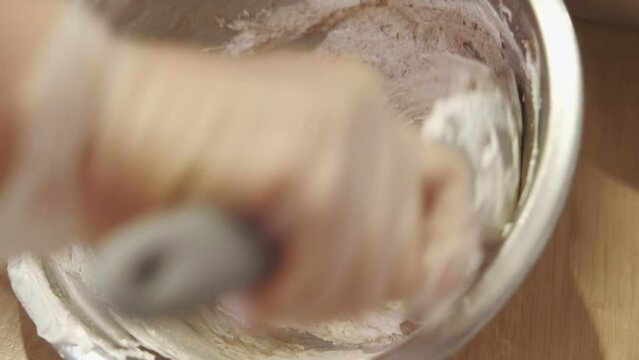 Video of chef making pasta dough for macaroons in bowl at kitchen.