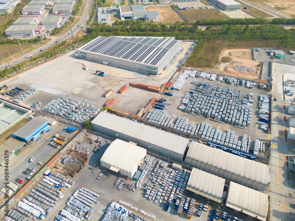 Wall mural Aerial top view of industry factory in urban city town. Inventory import and export business commercial, Automobile and automotive industry distribution logistic transport.