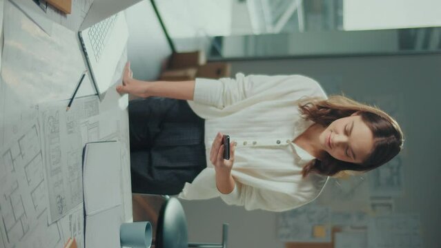 Vertical Video.Confident Female Engineer is Typing on a Laptop Computer, Working Online on a New Project. Female Manager is Doing a New Project. Engineering and Creativity New Product Development