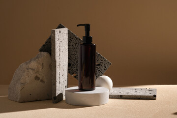 A pump bottle dispenser placed on a round podium, decorated with some gray stone podiums and big...