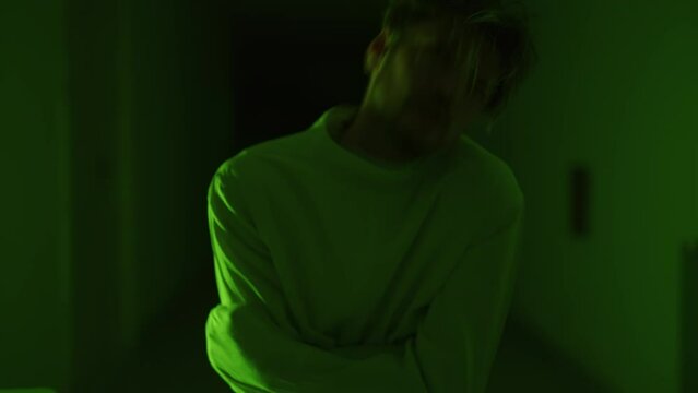 A mad male patient in straitjacket is going crazy in a mental hospital. Mentally ill man with psychic disorders and bipolar disease. Concept of paranoia or schizophrenia and madness or depression.