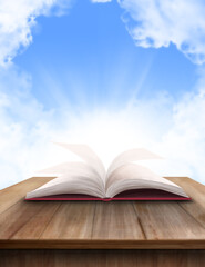 An open book with light shining around it.