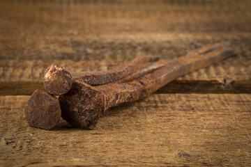Vintage hammer with nails on wood background