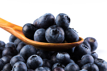 Fresh blueberries in wooden spoon