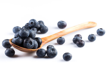 Fresh blueberries in wooden spoon
