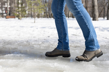 woman walking on ice in the park.
