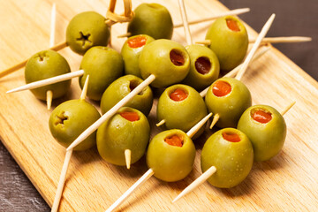 Olives stuffed with salmon on skewers.