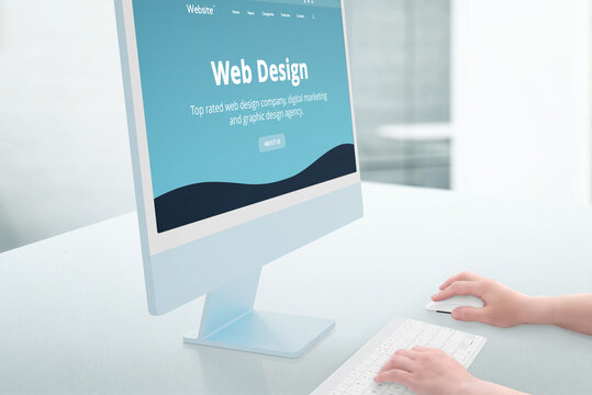 Web design studio showcase on modern computer display. Woman hands use keyboard and mouse. Studio office in background