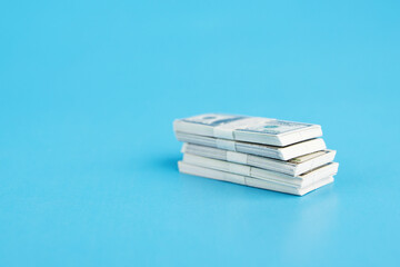 dollar pack, money background, american dollars banknotes cash on a blue background, copy space