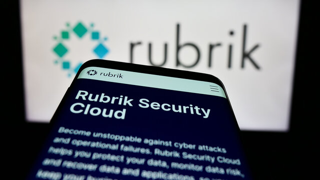 Stuttgart, Germany - 03-30-2023: Smartphone with website of US data security company Rubrik Inc. on screen in front of business logo. Focus on top-left of phone display.