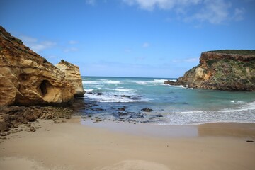 Beautiful view of a sandy beach with rocks during sunrise
