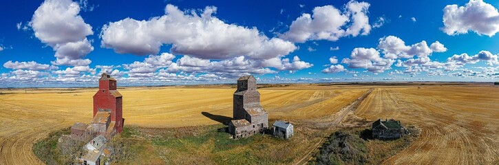 Panoramic aerial view of the Lepine Grain Elevators before the yellow fields under the sunlight