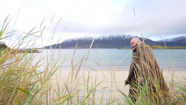 viking reenactor walking on the historic beach at Elgsnes, northern Norway