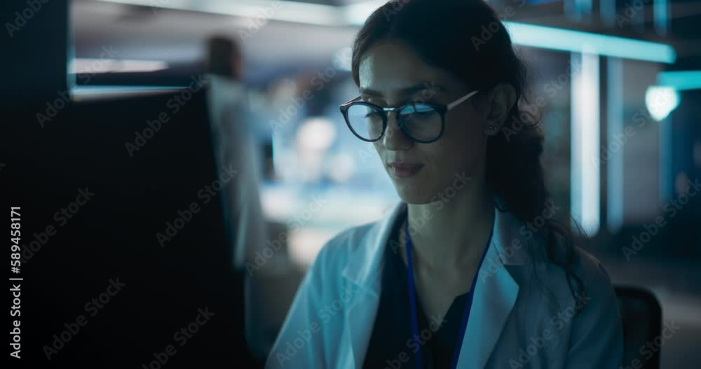 Poster Portrait of a Professional Female Specialist Using Computer at Work in Research and Development Agency. Young Multiethnic Engineer, Developer or Scientist Working in Development Technology Office