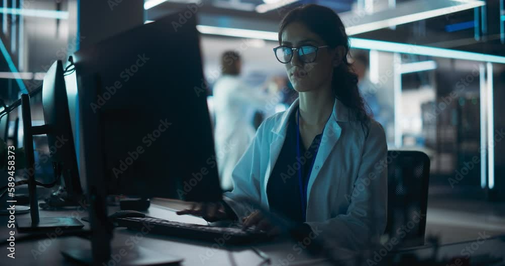 Poster Portrait of a Young Robotics Engineer Using Desktop Computer, Analyzing Robotic Machine Concept in a High Tech Factory. Female Scientist Researching Innovative Ways to Benefit and Progress Humanity