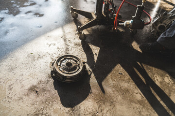 gearbox lying on the floor during clutch replacement, repair shop concept. High quality photo