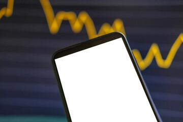 Black phone with blank mockup screen on rising stock graph. Closeup hand showing smartphone isolated white display. Online banking, Fund App use. Financial analyst on Invest Market, Bank collapse 2023