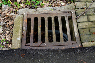 Sewage sewer grate in Germany on the road