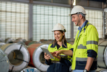 Factory apprenticeship. Man mentor teaching Female employees trainee operating machine looking...