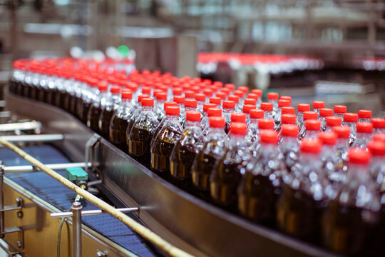Beverage factory interior. Conveyor flowing with bottles for carbonated water.