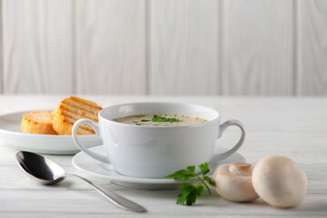 Mushroom cream soup on a white wooden board. side view