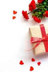 Gift box with red bow ribbon and paper heart on background for Valentines day.