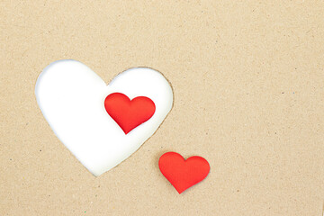 brown cardboard box. Cut into a heart shape. There is a small heart inside.