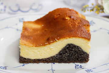 Cheesecake with a layer of poppy seeds on a plate.