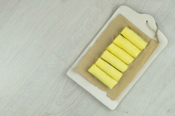 Preparation of homemade pancakes with filling on wood background. Ready for cooking. Frozen pancakes with filling. Top view.