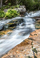 a close up view of some rocks and water in a stream