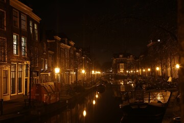 Canal with boats surrounded by buildings in Amsterdam