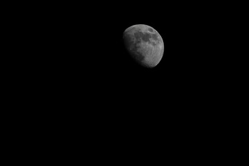 Greyscale of the moon in Waxing Gibbous phase in the night sky