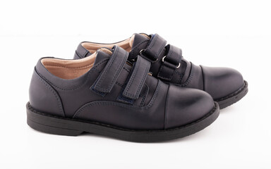 A pair of black leather shoes on a white background.