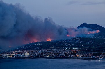 Forest fire near the sea coast in Alicante, Spain at night