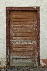 Vertical shot of an old brown wooden door