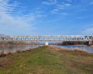 Steel frame railway bridge over the Elbe River on a sunny winter day