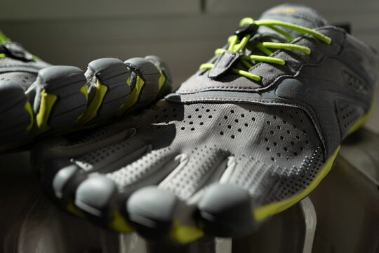 Closeup shot of a pair of gray green toe shoes for sport