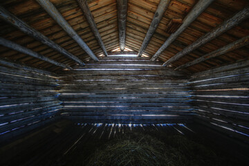 Interior of a small shack used to store hay